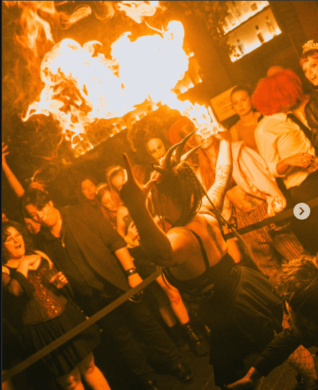 SIN FIRE performer breathing fire in front of a crowd